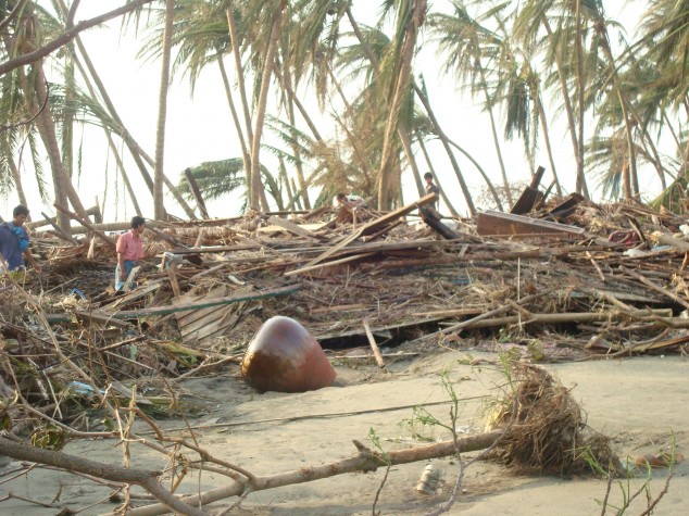 Survivors survey flattened buildings in the Irrawaddy Delta after Cyclone Nargis, May 2008